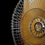 A modern home fan placed in a living room, illustrating AC fan mode vs normal fan comparison for better home cooling and comfort.