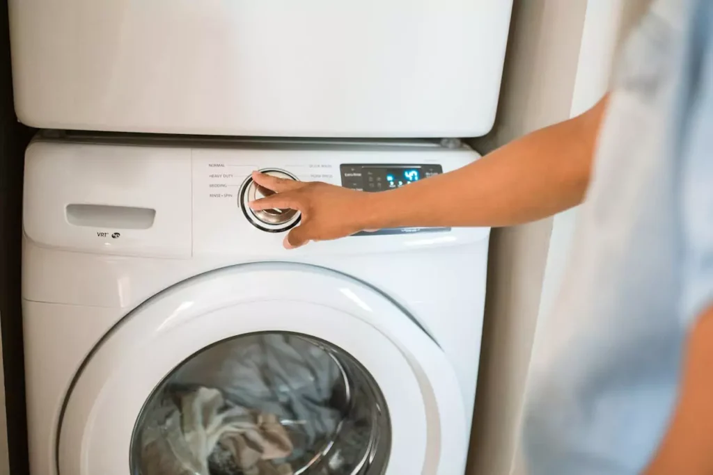 Washer and dryer appliances stacked in a home laundry area, ready for donation and reuse.
