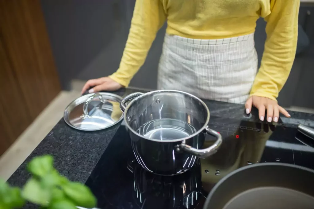 woman cooking at an induction stove